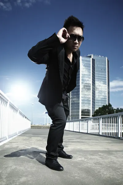 Asian man posing on the bridge — Stock Photo, Image