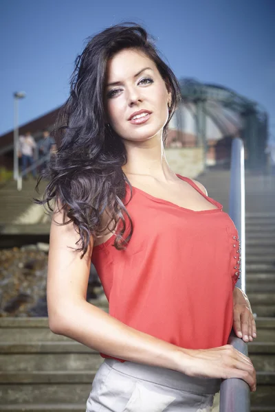 Brunette girl posing on the stairs — Stock Photo, Image