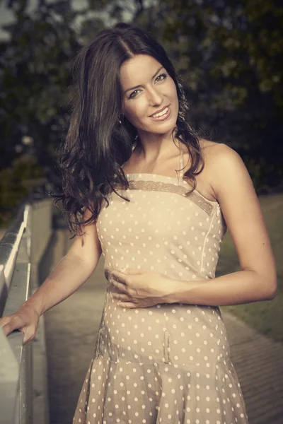 Brunette girl posing on the stairs — Stock Photo, Image