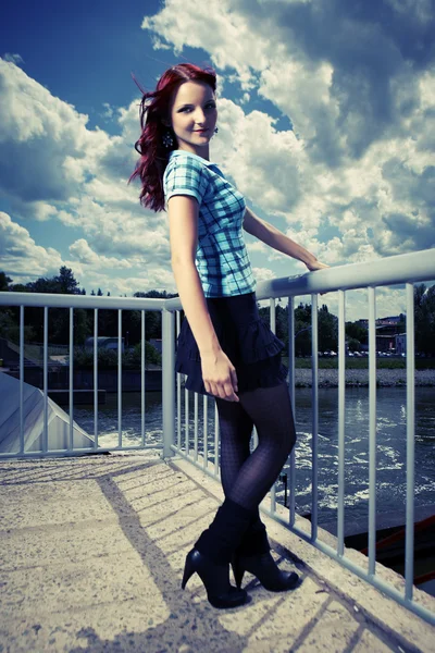 Girl posing in summer light on floodgate — Stock Photo, Image