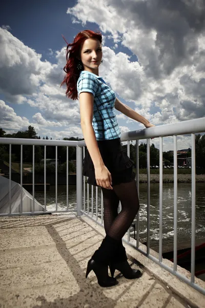 Girl posing in summer light on floodgate — Stock Photo, Image