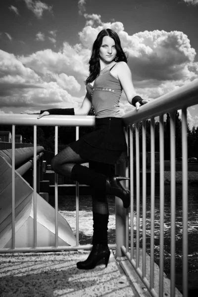 Monochrome portrait of girl on floodgate — Stock Photo, Image