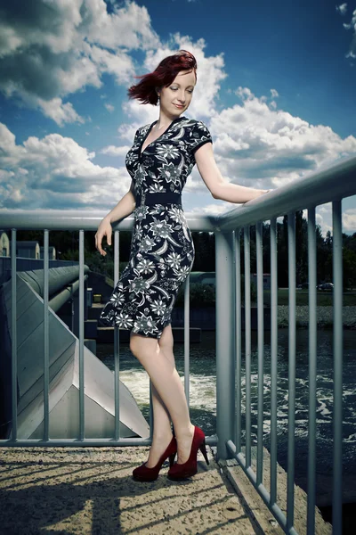 Nice lady on floodgate in wind — Stock Photo, Image