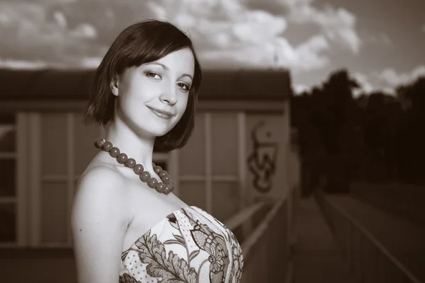 Monochrome portrait of girl on floodgate — Stock Photo, Image