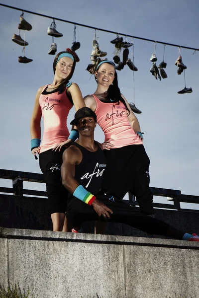 Fitness trio posing on wall — Stock Photo, Image