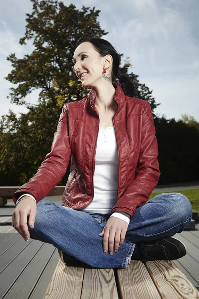 Brunette woman sitting in lotus position — Stock Photo, Image