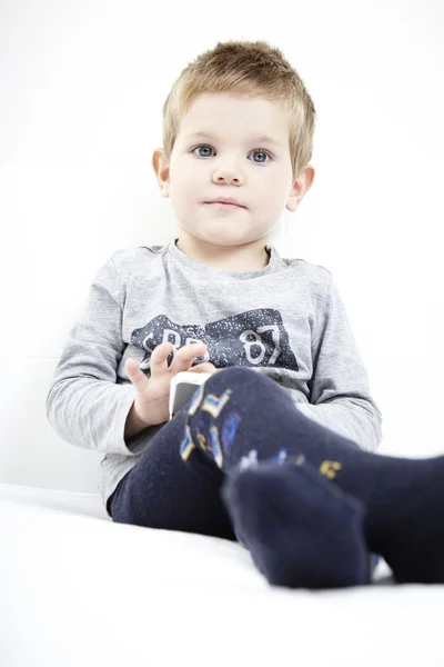 Garçon sur le lit à la maison posant pour portrait — Photo