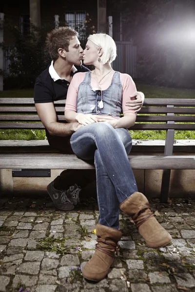 Lovely kiss on park bench — Stock Photo, Image