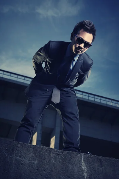 Asian man posing on the bridge — Stock Photo, Image