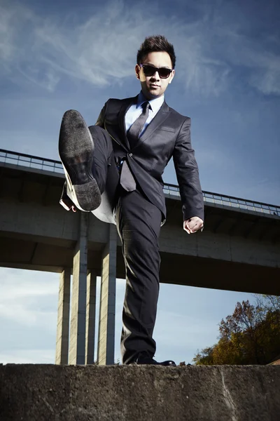 Asian man posing on the bridge — Stock Photo, Image