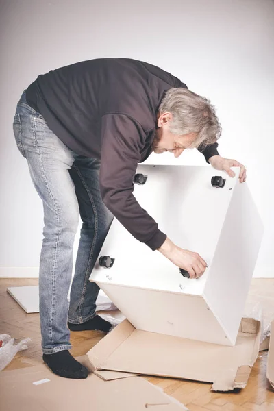 Man Assembling Set Three Laminated Wooden Drawers — Stock Photo, Image