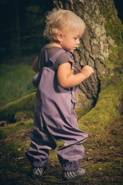 One and half year old baby girl posing in nature