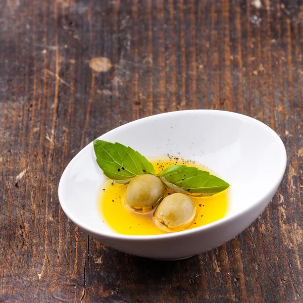 Olives and olive oil in bowl