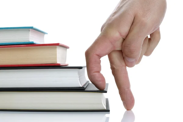 Fingers climbing hardback book staircase — Stock Photo, Image