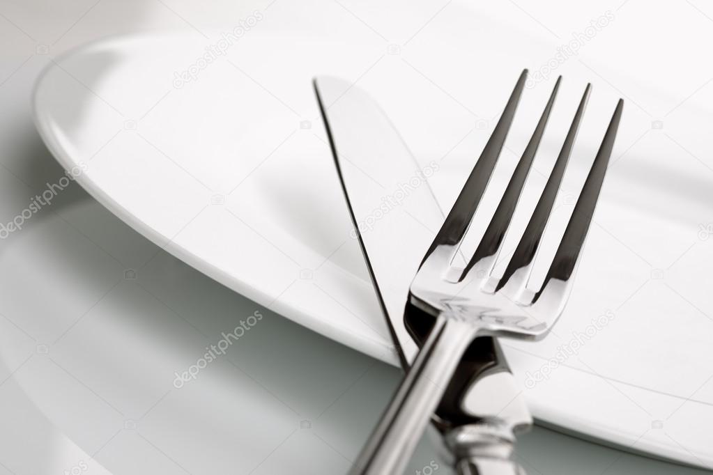 Dinner plate, knife and fork silverware Stock Photo by ©BrianAJackson