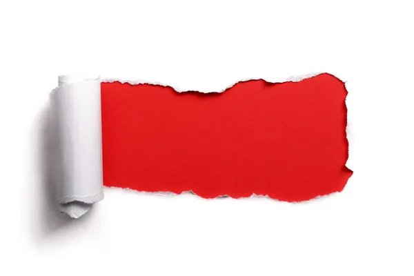 Tearing a paper frame hole with red background — Stock Photo, Image