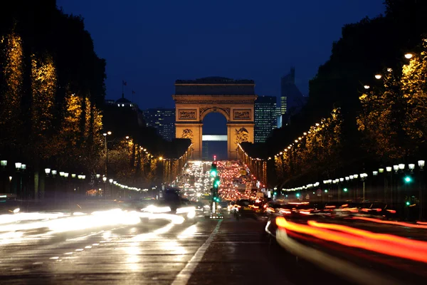 Arc de triomphe en de champs-Elysées avenue nachts — Stockfoto