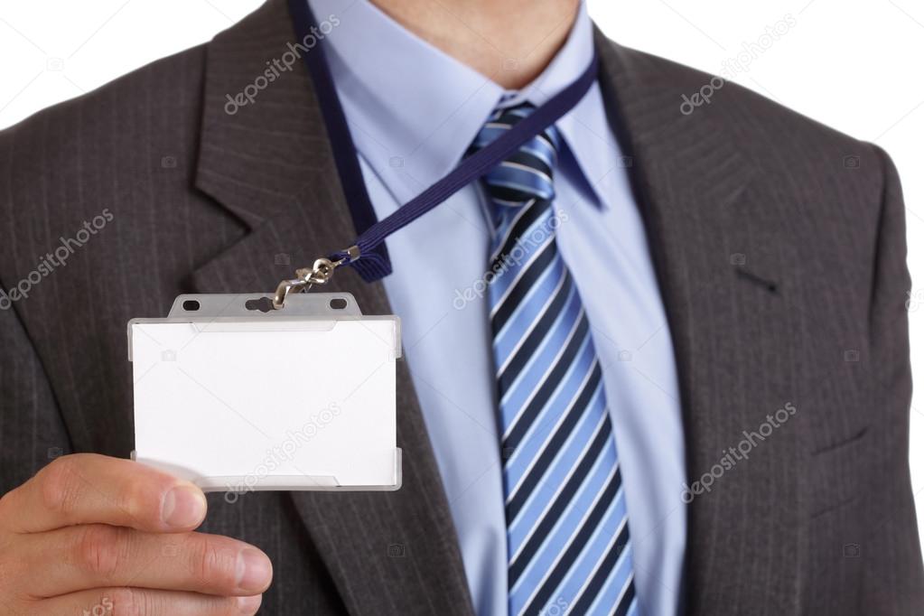 Businessman holding blank ID badge