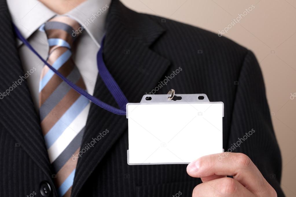 Businessman holding blank ID badge
