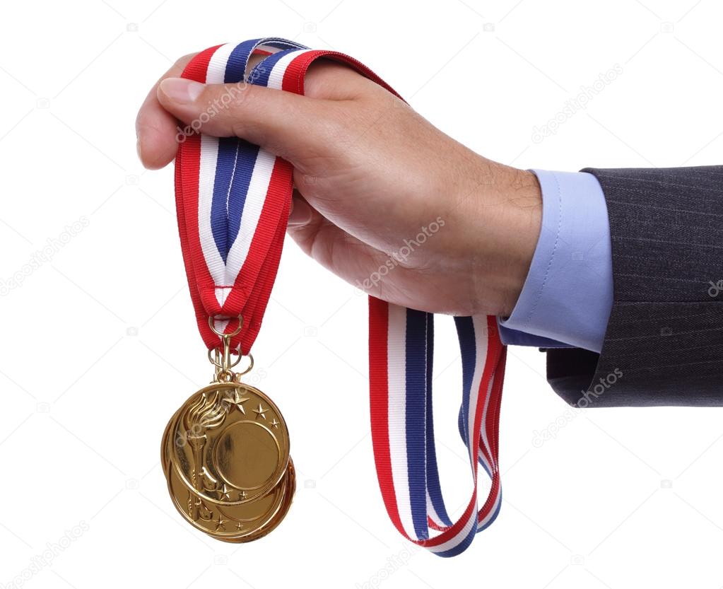 Businessman holding gold medal
