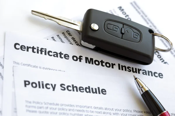 Motor insurance certificate with car key — Stock Photo, Image