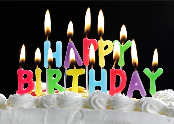 Happy birthday candles on a cake — Stock Photo, Image