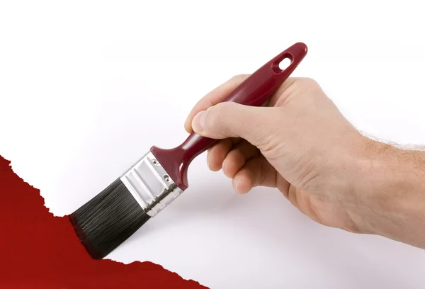 Paintbrush resim duvar kırmızı tutan el — Stok fotoğraf