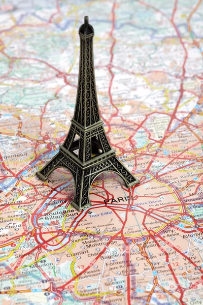 Statue of Eiffel Tower on map of Paris — Stock Photo, Image