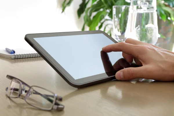 Finger touching screen of a digital tablet — Stock Photo, Image