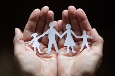 Paper chain family protected in cupped hands clipart