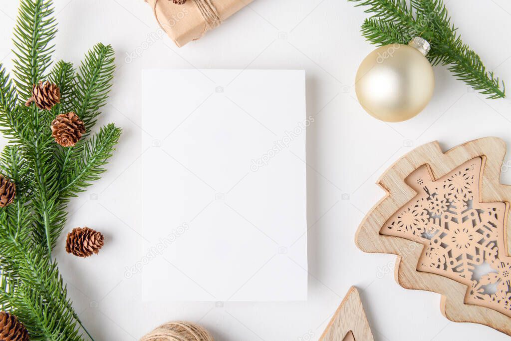 Christmas 5x7 card mockup template with fir twigs and golden stars on white background. Design element for Christmas and New Year congratulation, rsvp, thank you, greeting or invitation card