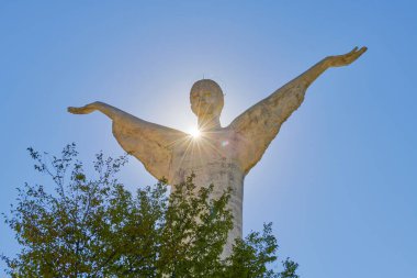 Maratea 'da kurtarıcı İsa' nın heykeli mavi gökyüzüne karşı güneş ışınlarıyla, Basilicata, İtalya. Kurtarıcı dünyayı elleriyle kucaklıyor, dini sevgi ve kabullenme kavramlarıyla. Paskalya arkaplanı