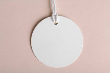 Neutral round gift tag mockup on beige background, minimal design, label tag mockup, Wedding favor tag for souvenir, sign for greeting message close up, element for design