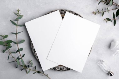 Two Wedding stationery invitation card mockup 5x7 on grey background with eucalyptus, Menu card mockup with festive wedding or birthday table setting, silver retro vintage plate with blank card mockup