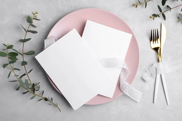 Two Wedding stationery invitation card mockup 5x7 on grey background with eucalyptus, Menu card mockup with festive wedding or birthday table setting, pink ceramic plate. Minimal blank card mockup