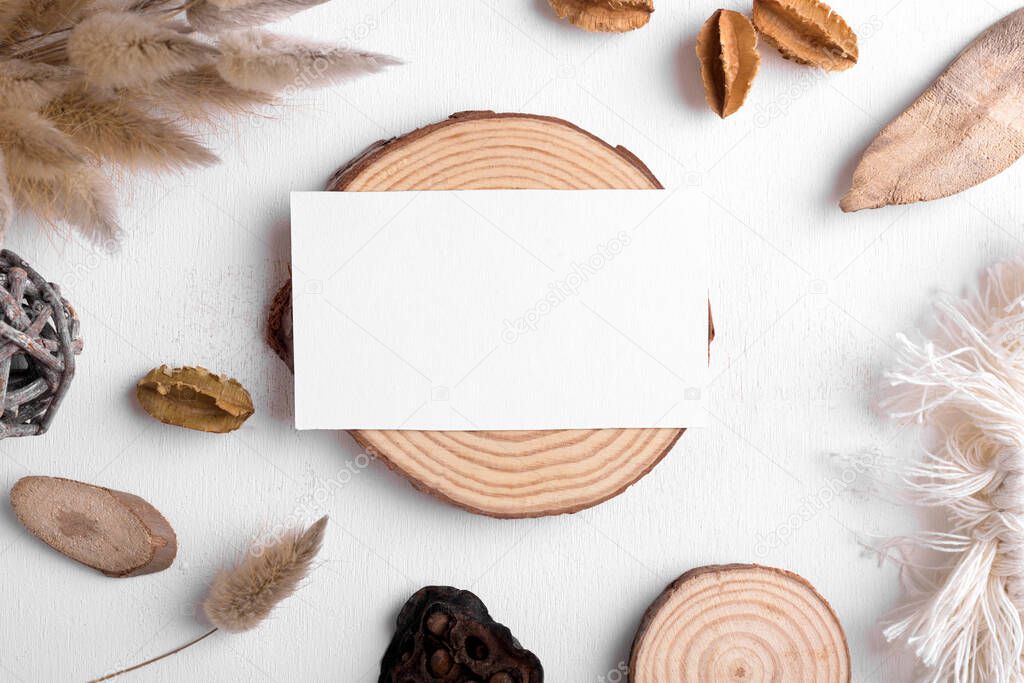 Boho business card mockup template, empty stationery card with dry plants, wood and boho decor on a white background and design element for wedding invitation, rsvp, thank you card, greeting