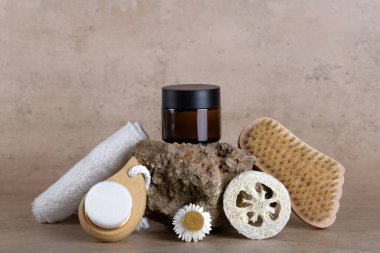 Amber glass jar mockup for moisturizer cream on stone podium on beige terracotta background with set for bathroom accessories, skin and body care, Natural cosmetic packaging mockup, skincare routine