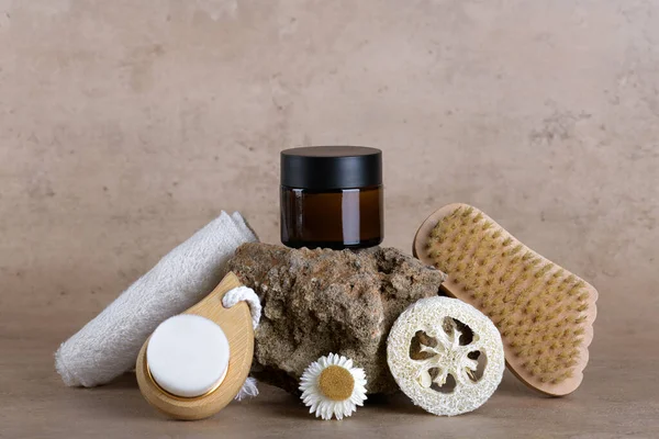 Amber glass jar mockup for moisturizer cream on stone podium on beige terracotta background with set for bathroom accessories, skin and body care, Natural cosmetic packaging mockup, skincare routine