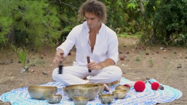Man Playing Tibetian Singing Bowls Sitting Outdoors Meditation Buddhist Healing — Stock Video