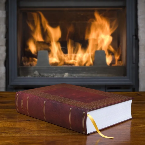 Old book and fireplace — Stock Photo, Image