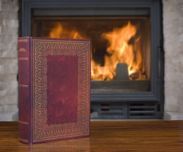 Old book and fireplace — Stock Photo, Image