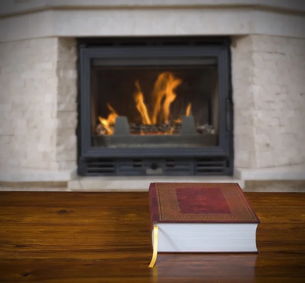 Old book and fireplace — Stock Photo, Image