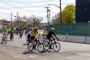 Bitiş çizgisine yakın Staten Island, New York 'taki Beş Boro Bisiklet Turuna motorcular katılıyor.