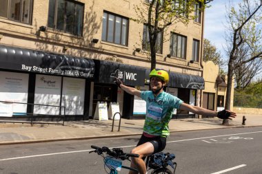 Bitiş çizgisine yakın Staten Island, New York 'taki Beş Boro Bisiklet Turuna motorcular katılıyor.