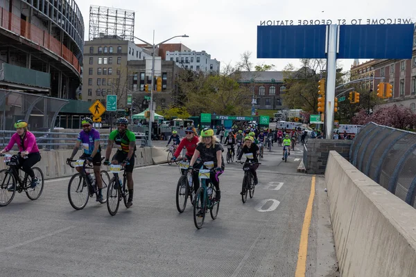 Bitiş çizgisine yakın Staten Island, New York 'taki Beş Boro Bisiklet Turuna motorcular katılıyor.
