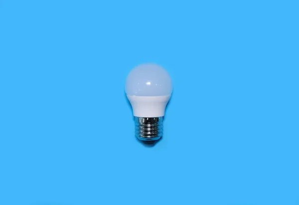 LED lamp on a bright blue background. High quality photo. — ストック写真