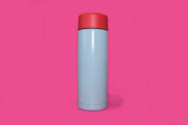 Thermos on a bright pink background. High quality photo. — Stockfoto