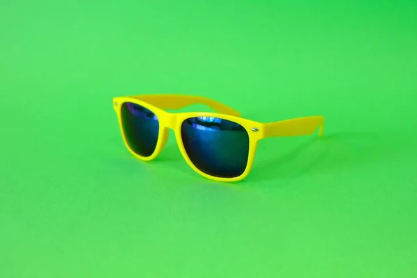 Sunglasses on a green background. High quality photo — Stok fotoğraf