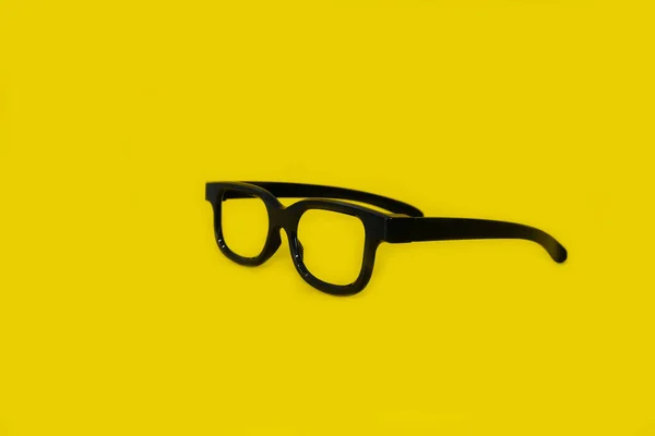 Glasses on a bright yellow background — Stock Photo, Image