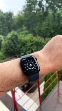 Bir erkeğin elindeki akıllı saat, yağmur yağıyor, hava durumunu gösteriyor. Yüksek kalite 4k görüntü